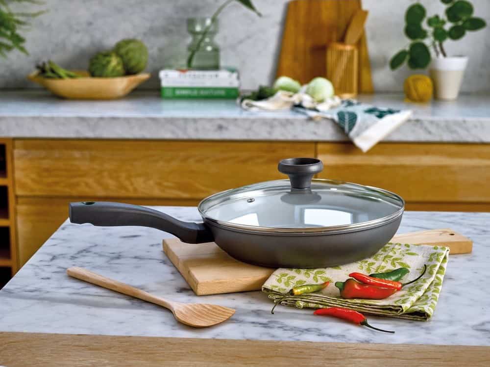 Large frying pan with a lid on a kitchen counter top