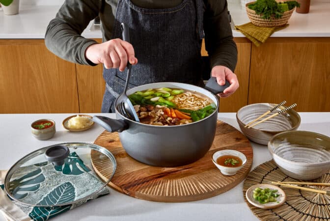 Man holding handle of stockpot