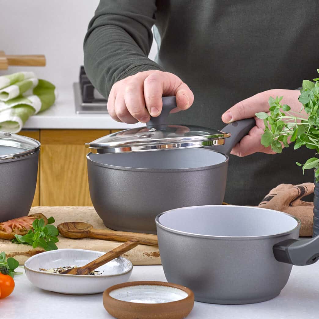 Man lifting lid off saucepan